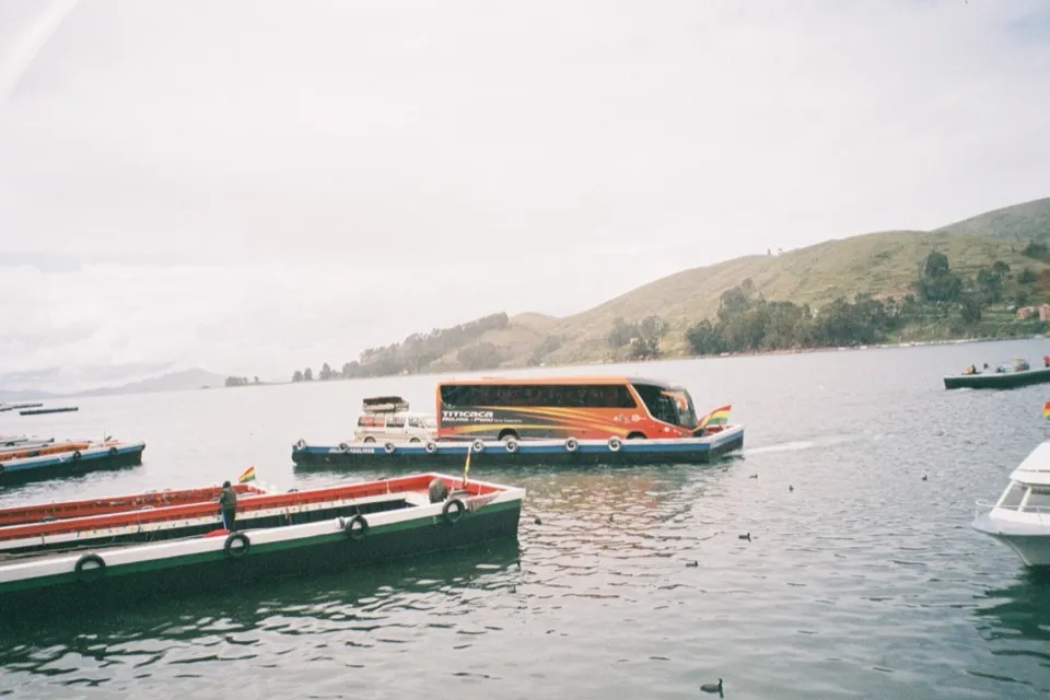 A coach crossing Lake Titicaca on a flat barge at Tiquina