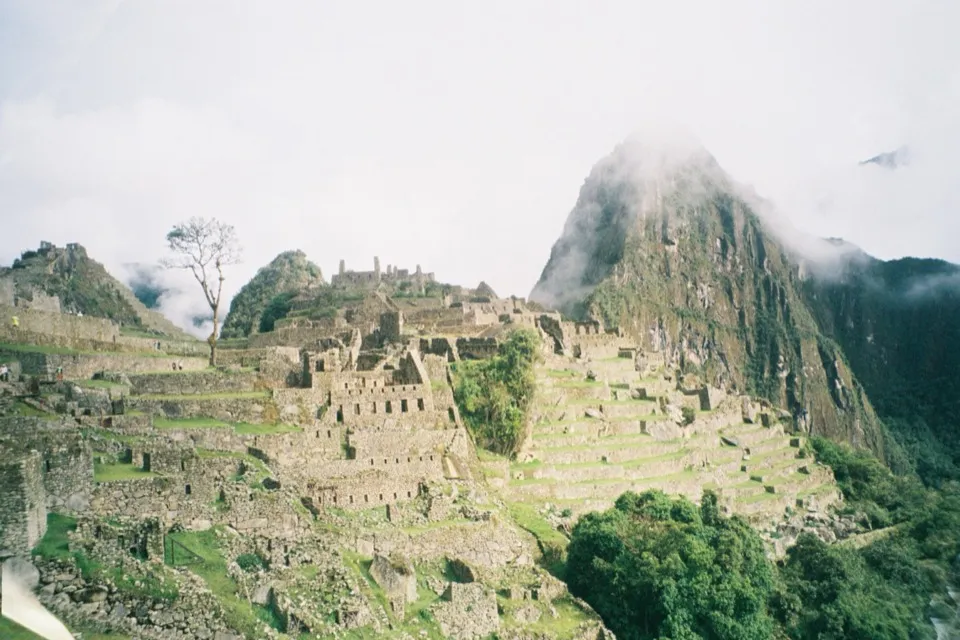 Machu Picchu with Huayna Picchu rising into the cloud behind